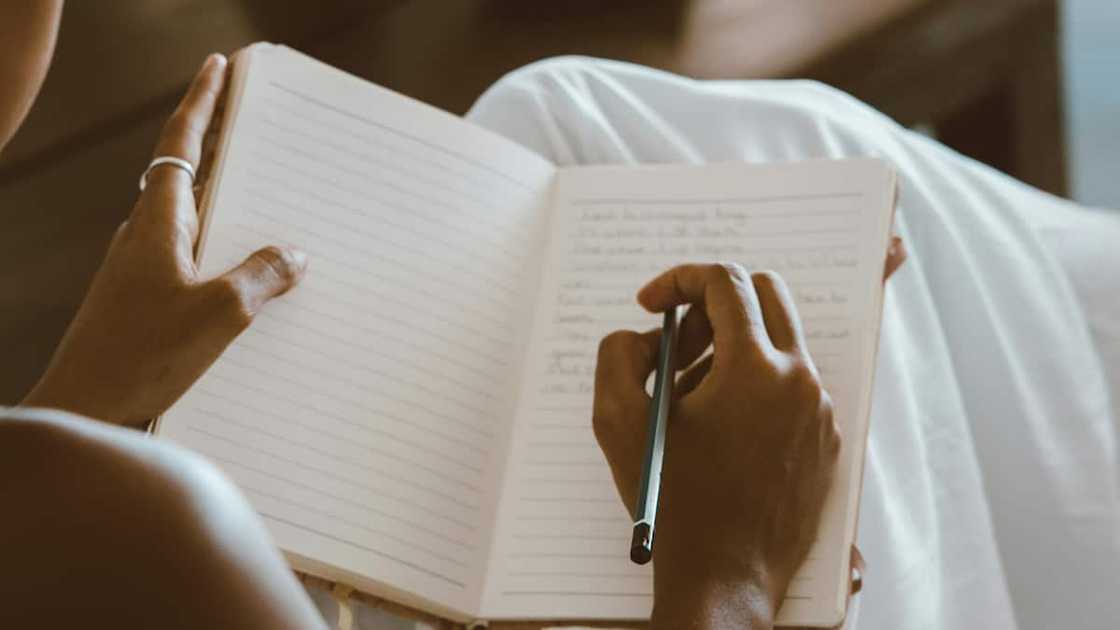 A woman writing in a notebook