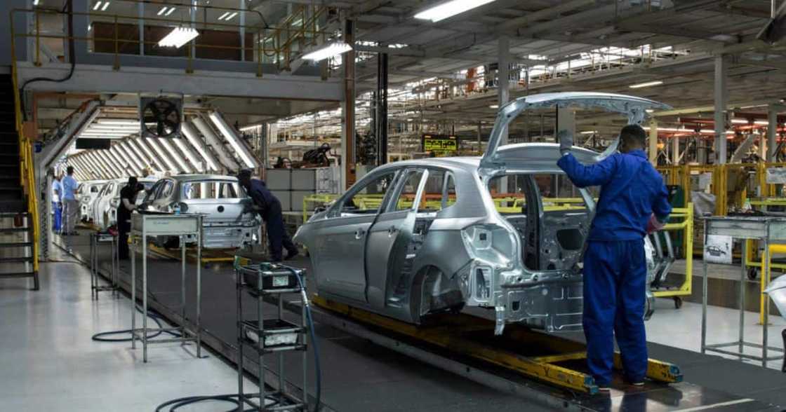 Employees worked on manufacturing a car at a Volkswagen plant. Employees worked on manufacturing a car at a Volkswagen plant.