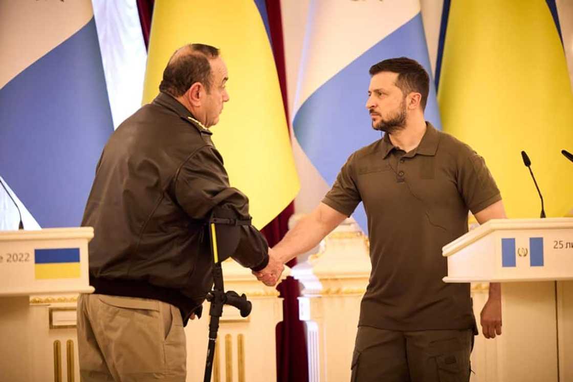 This handout picture taken and released by Ukrainian Presidential press-service on July 25, 2022 shows Ukraine's President Volodymyr Zelensky (R) shaking hands with Guatemala President Alejandro Giammattei following talks in Kyiv This handout picture taken and released by Ukrainian Presidential press-service on July 25, 2022 shows Ukraine's President Volodymyr Zelensky (R) shaking hands with Guatemala President Alejandro Giammattei following talks in Kyiv