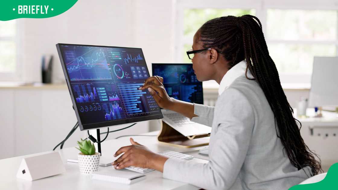 A female data analyst using KPI Dashboard with financial analytics graphs. A female data analyst using KPI Dashboard with financial analytics graphs.