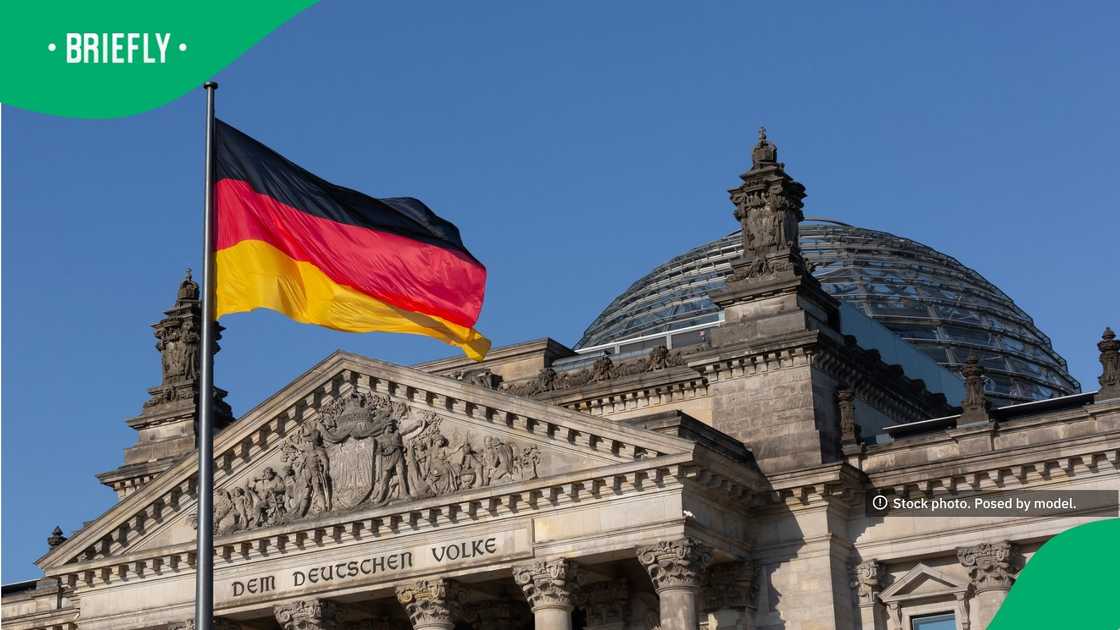 The grand facade of the Reichstag building featured intricate stone carvings, and its iconic large glass dome gleamed in the sunlight The grand facade of the Reichstag building featured intricate stone carvings, and its iconic large glass dome gleamed in the sunlight