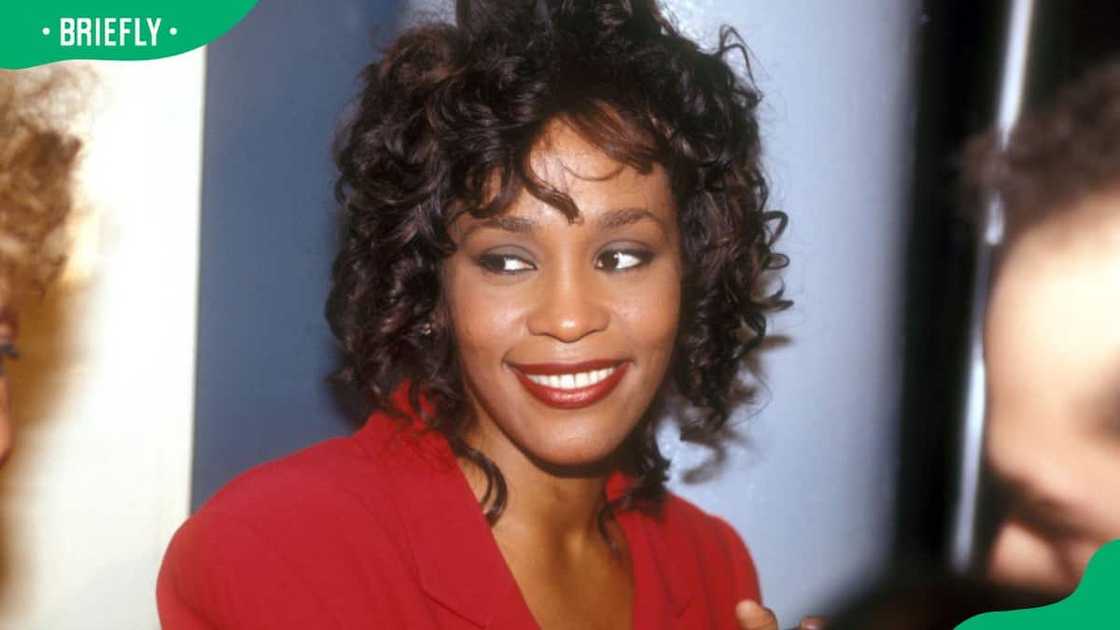 The late Whitney Houston posing for a photo The late Whitney Houston posing for a photo