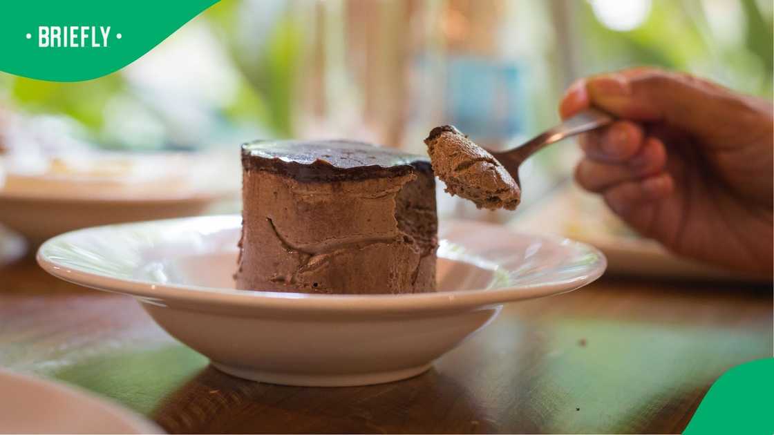 Picking chocolate mousse from a spoon. Picking chocolate mousse from a spoon.