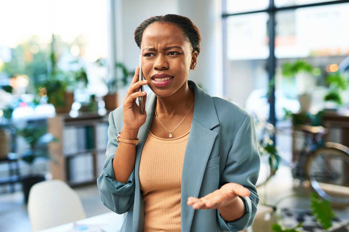 An African female is having a mobile conversation An African female is having a mobile conversation