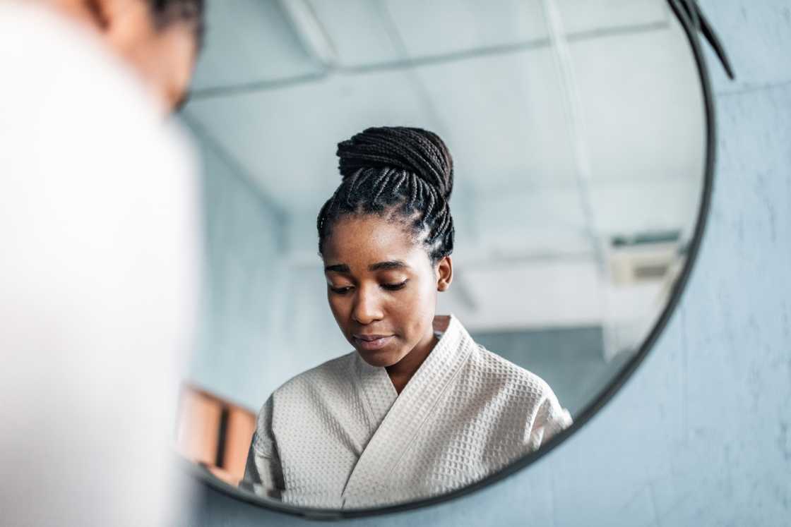A woman alone in a bathroom, struggling not to cry. A woman alone in a bathroom, struggling not to cry.
