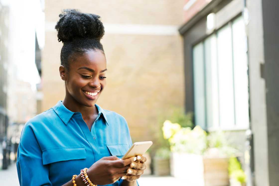 A woman laughed while scrolling through her phone. A woman laughed while scrolling through her phone.