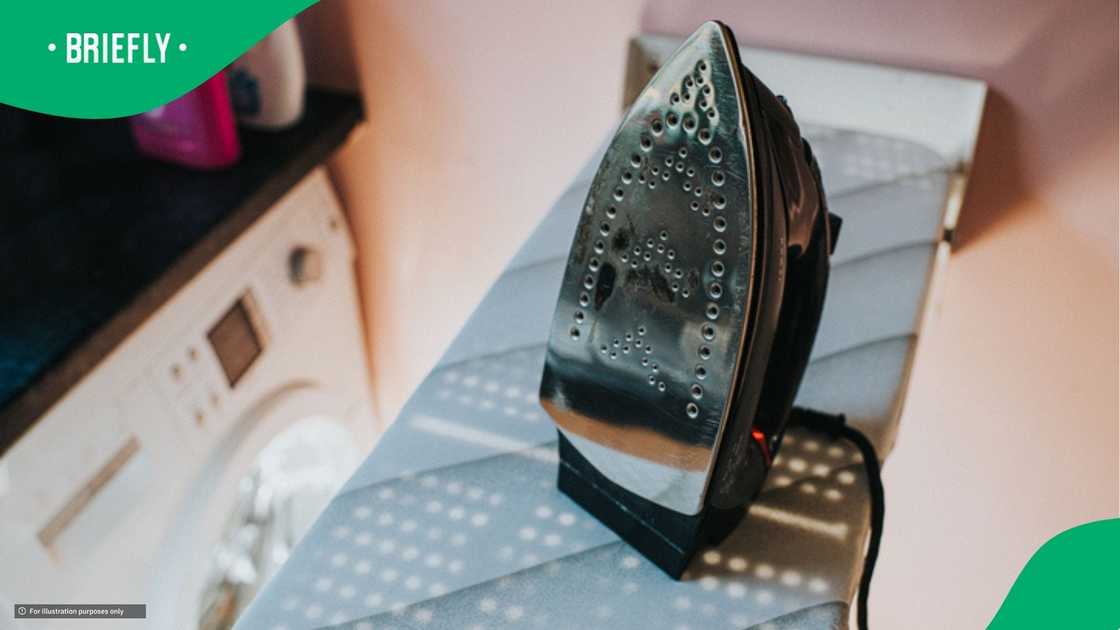 A woman cleaned her iron with ease A woman cleaned her iron with ease