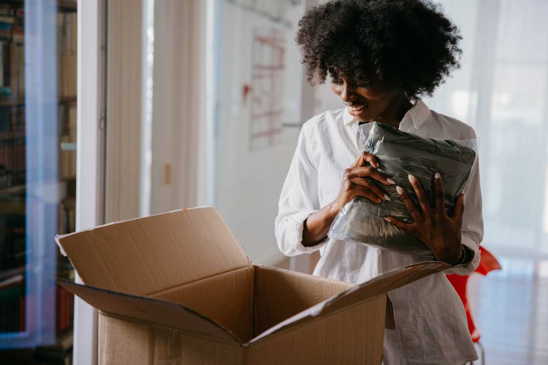 A stock photo of a woman pleased with her package A stock photo of a woman pleased with her package