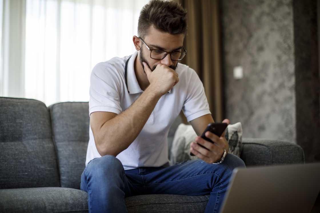 Man looking at his phone. Man looking at his phone.