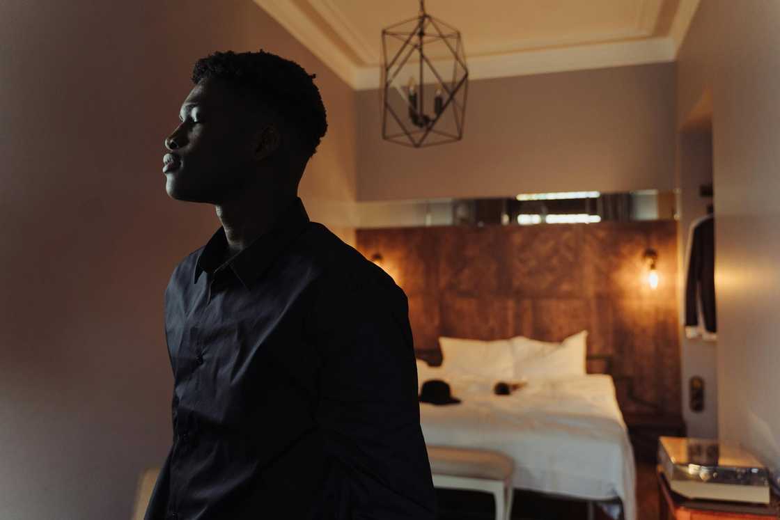 A stressed man standing indoors A stressed man standing indoors