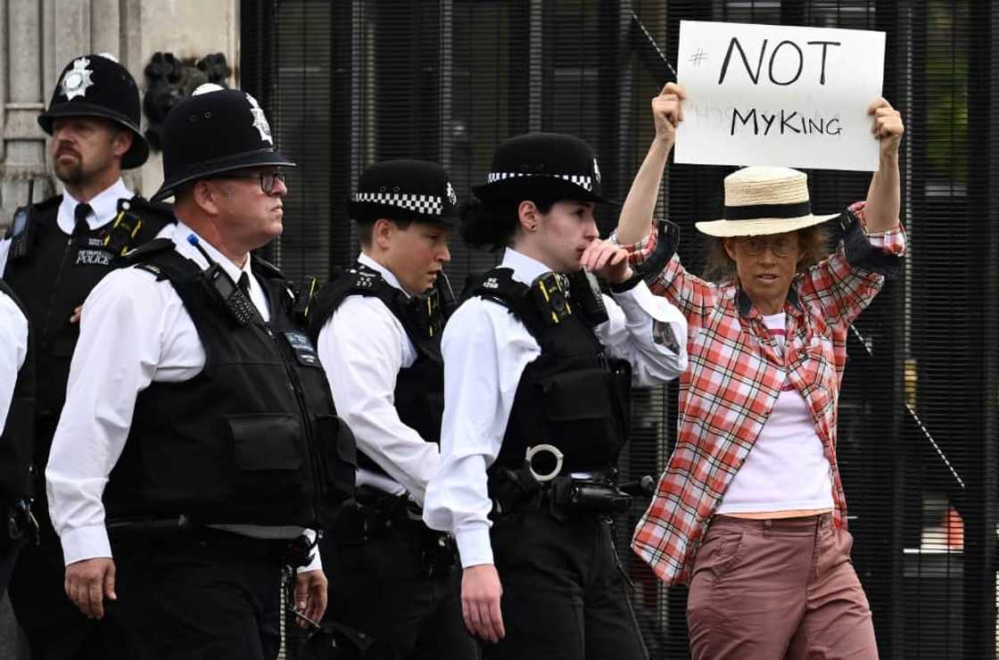 One protester was ushered away from the UK parliament for holding up a sign against King Charles III One protester was ushered away from the UK parliament for holding up a sign against King Charles III
