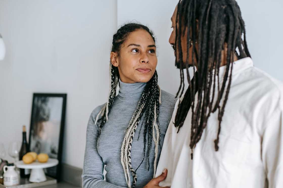 A woman looks at her partner during a tense conversation. A woman looks at her partner during a tense conversation.