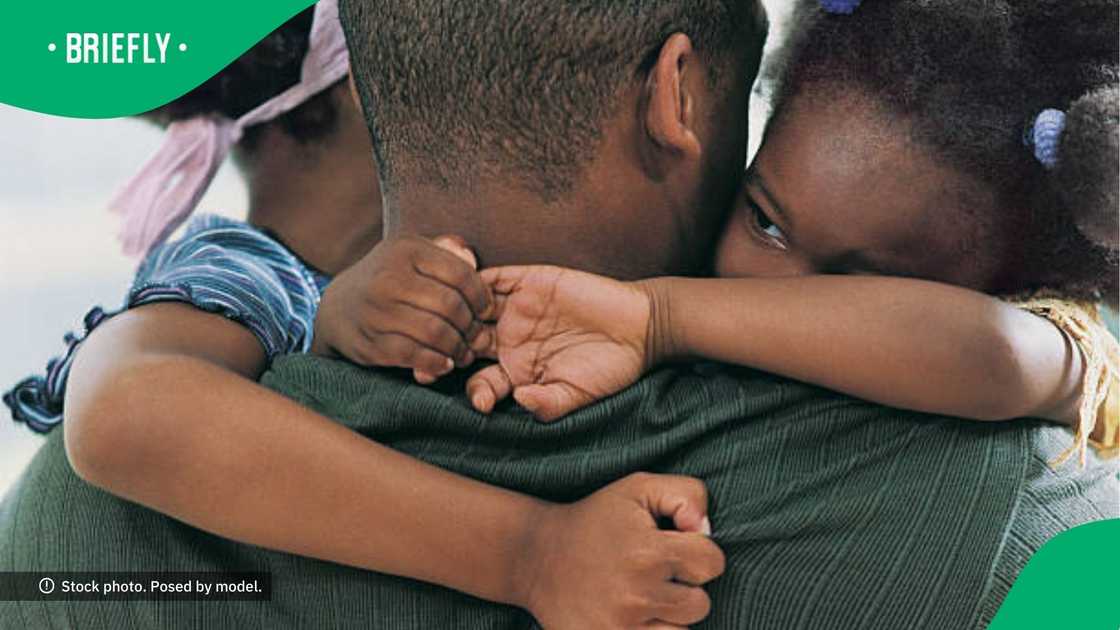 A father hugging his children A father hugging his children