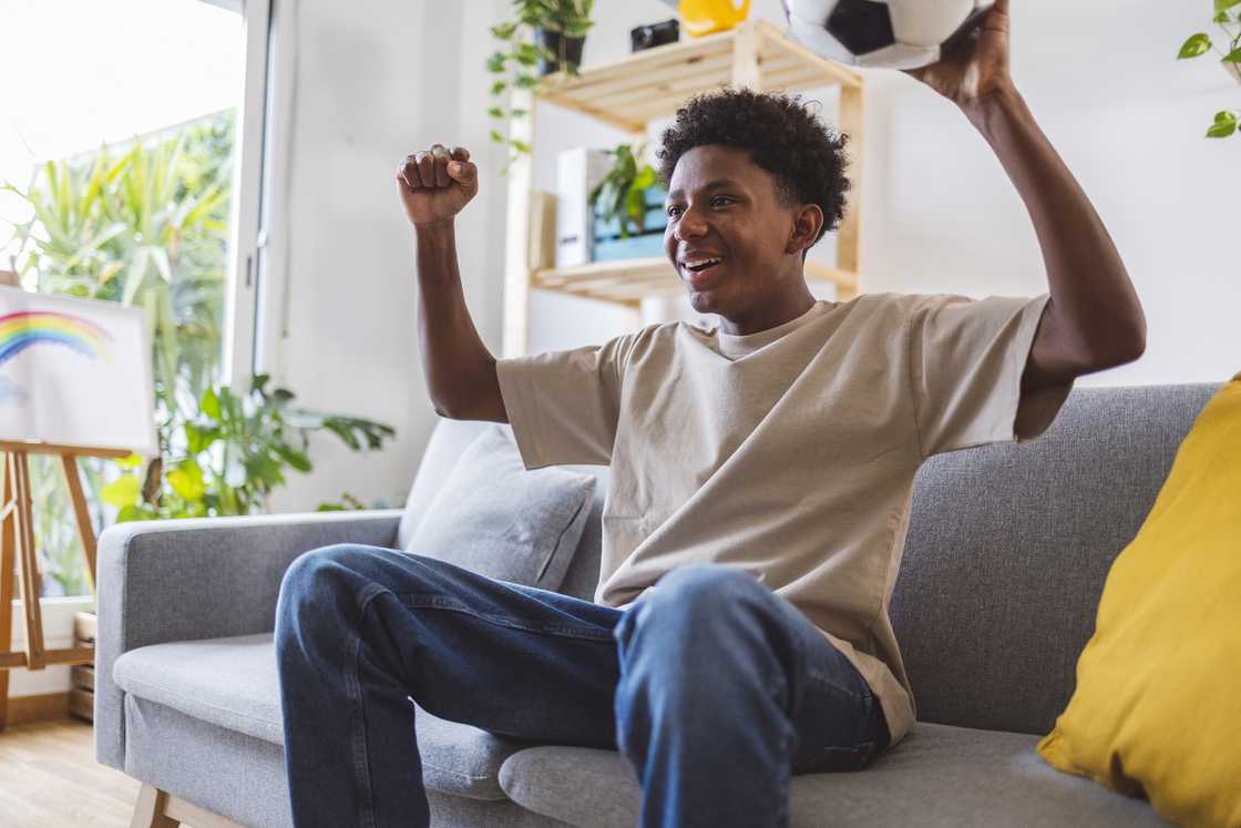 A teen watching football A teen watching football
