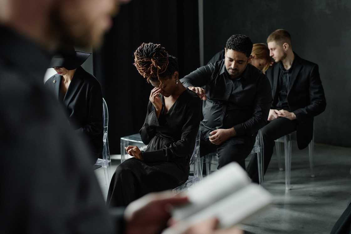 Shocked faces of mourners during a funeral service. Shocked faces of mourners during a funeral service.
