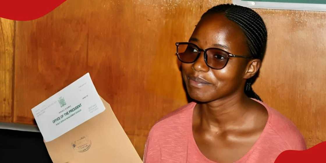 Photo of Merphine Moonga holding the letter of appointment. Photo of Merphine Moonga holding the letter of appointment.