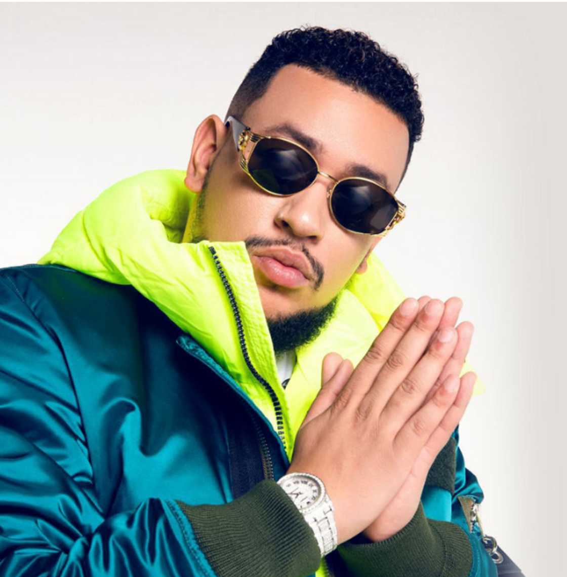 The late AKA in a lime green puffer coat with jade jacket