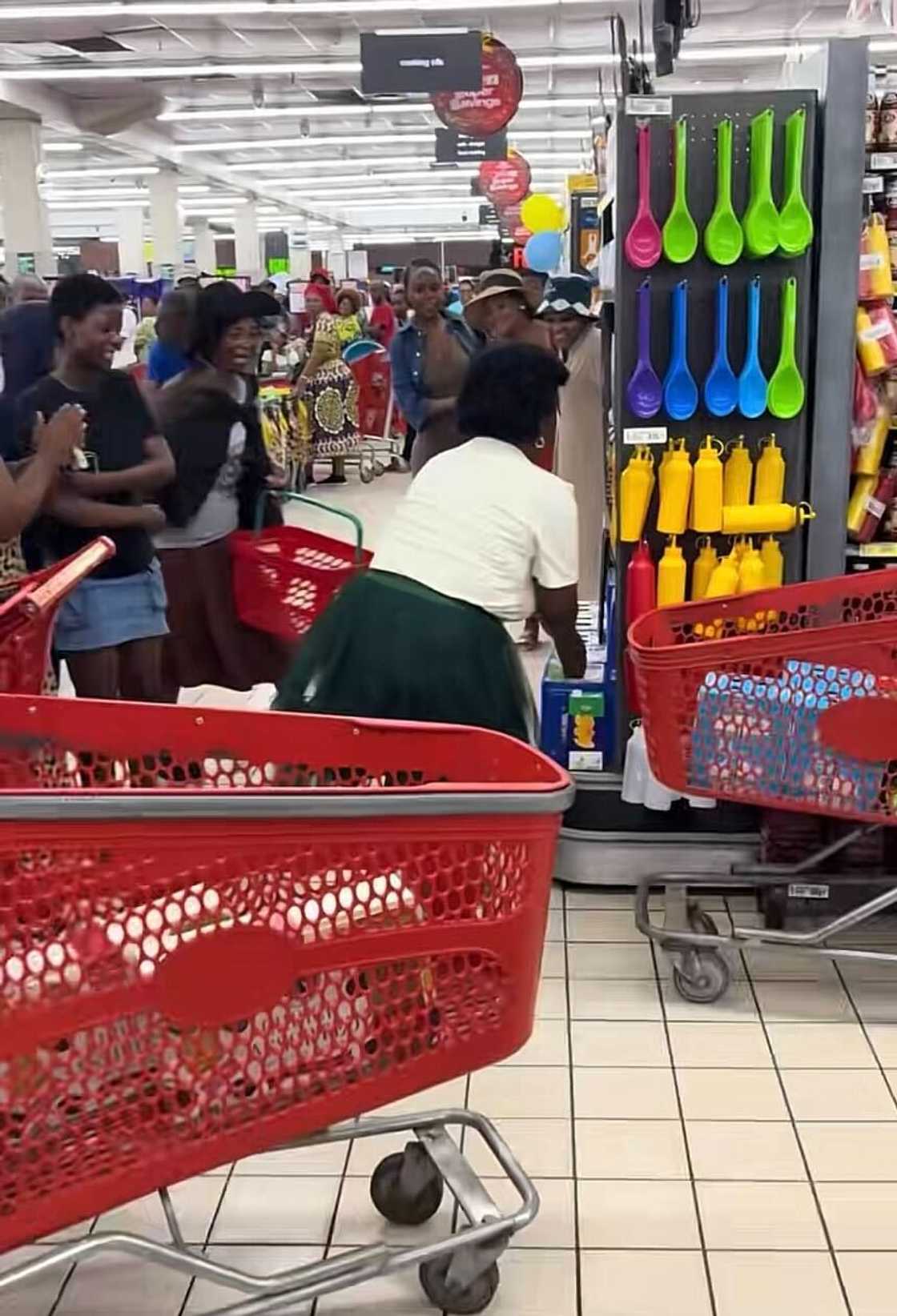 A woman in South Africa stood ready for the bell to ring before starting her trolley dash. A woman in South Africa stood ready for the bell to ring before starting her trolley dash.