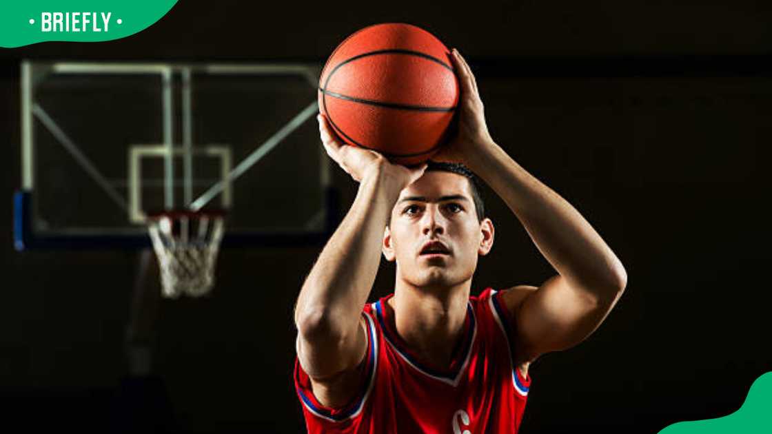 Basketball player shooting at the hoop Basketball player shooting at the hoop