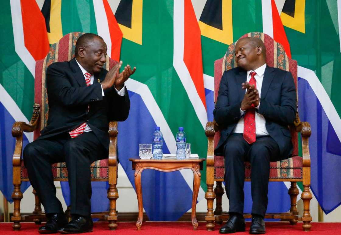 South African President Cyril Ramaphosa and his deputy David Mabuza react during a swearing-in ceremony