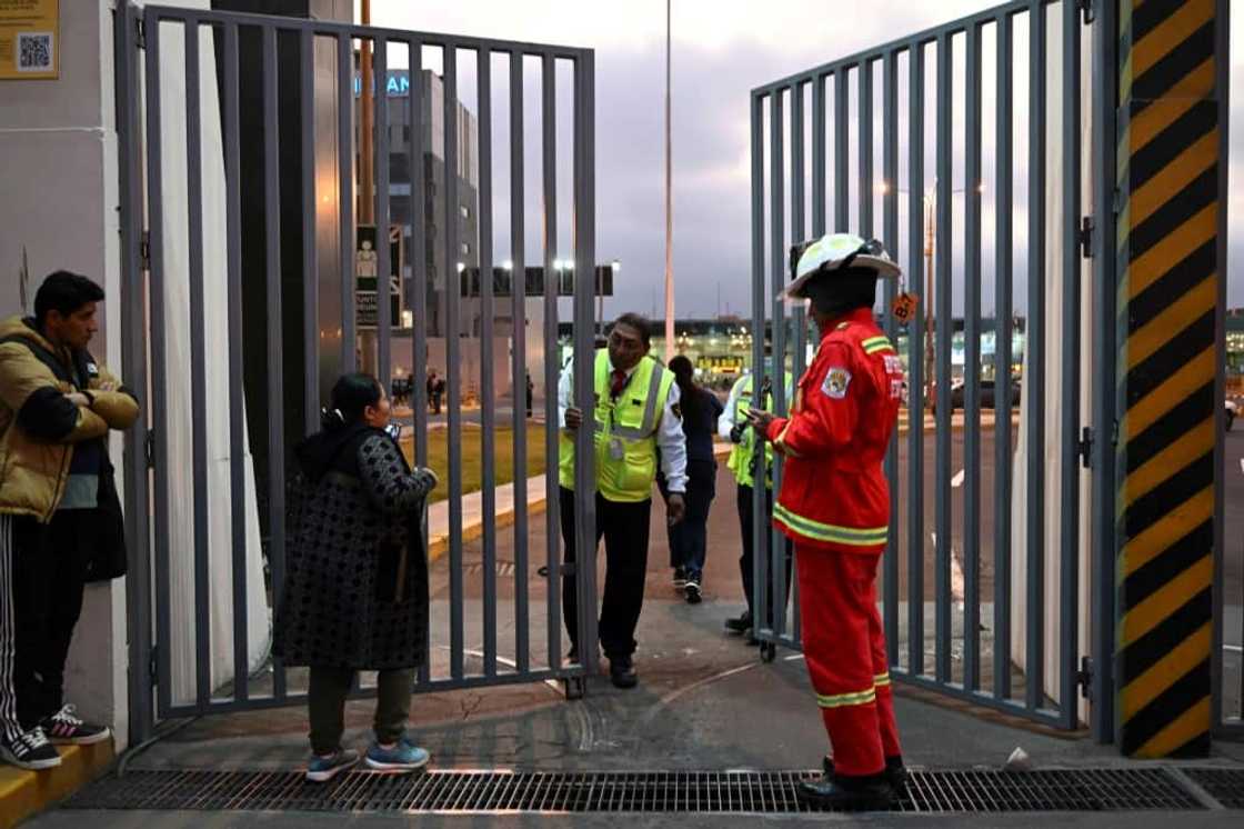 Passengers who missed their flights are seen outside the closed Lima airport after a collision between a plane and a fire truck on November 18, 2022