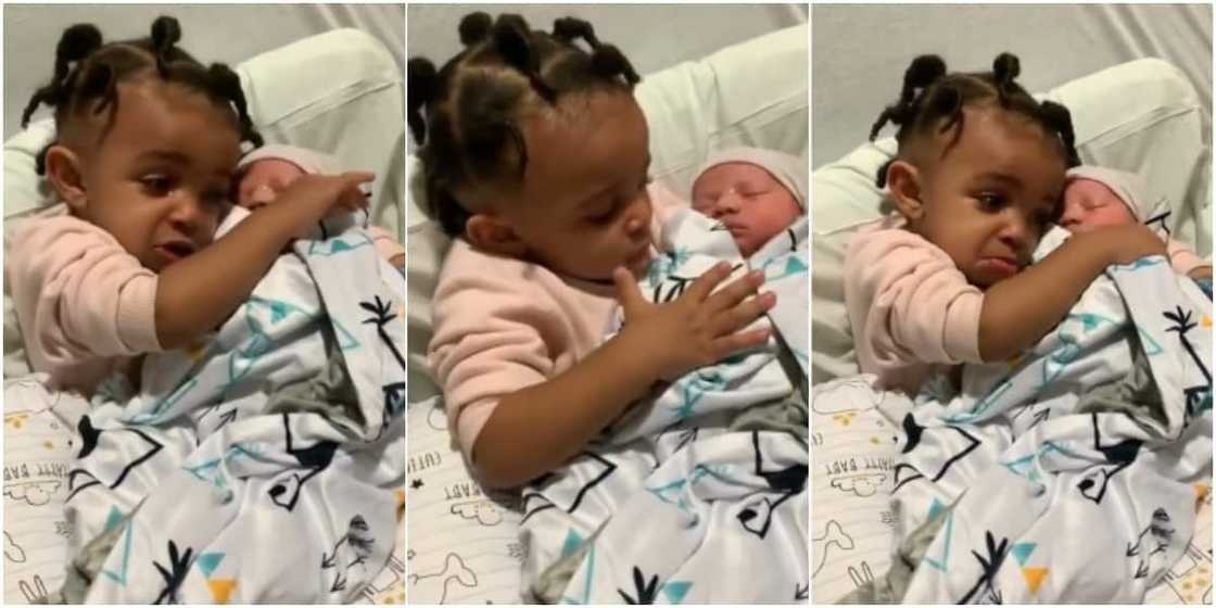 The little girl is seeing her baby brother for the first time