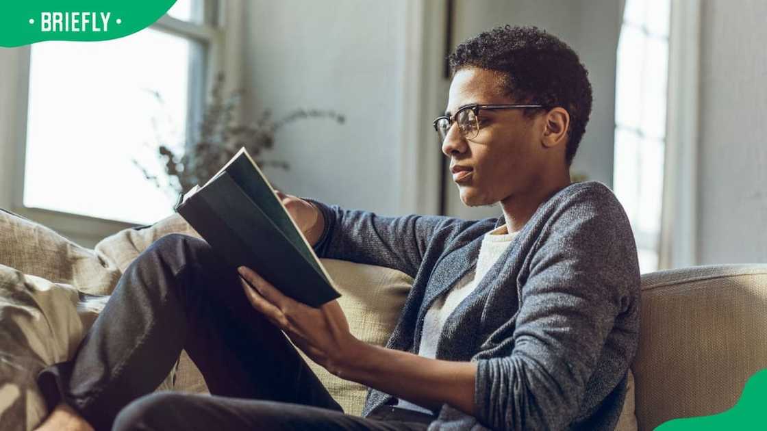 A young man reading a book A young man reading a book