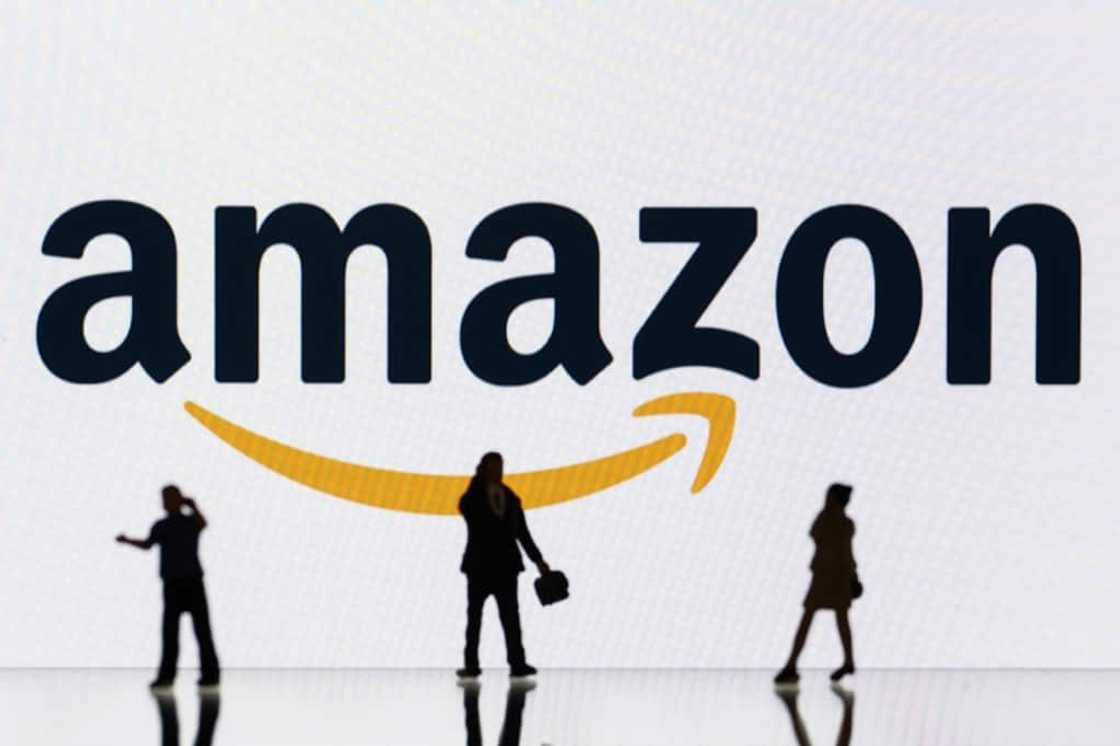 This illustration photograph taken on October 30, 2023, in Mulhouse, eastern France, shows figurines next to a screen displaying a logo of Amazon, a US multinational technology e-commerce company. This illustration photograph taken on October 30, 2023, in Mulhouse, eastern France, shows figurines next to a screen displaying a logo of Amazon, a US multinational technology e-commerce company.
