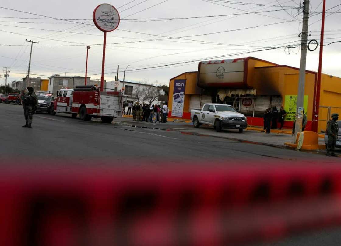 Soldiers, firefighters and forensic experts work at the site of an arson attack in the Mexican border city of Ciudad Juarez Soldiers, firefighters and forensic experts work at the site of an arson attack in the Mexican border city of Ciudad Juarez