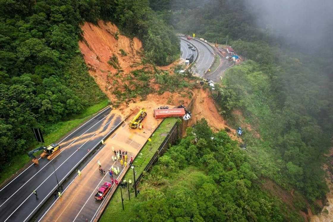 Aerial view of the landslide that hit highway BR 367 in southern Brazil, sweeping away some 20 vehicles and leaving at least two people dead and dozens missing. Aerial view of the landslide that hit highway BR 367 in southern Brazil, sweeping away some 20 vehicles and leaving at least two people dead and dozens missing.
