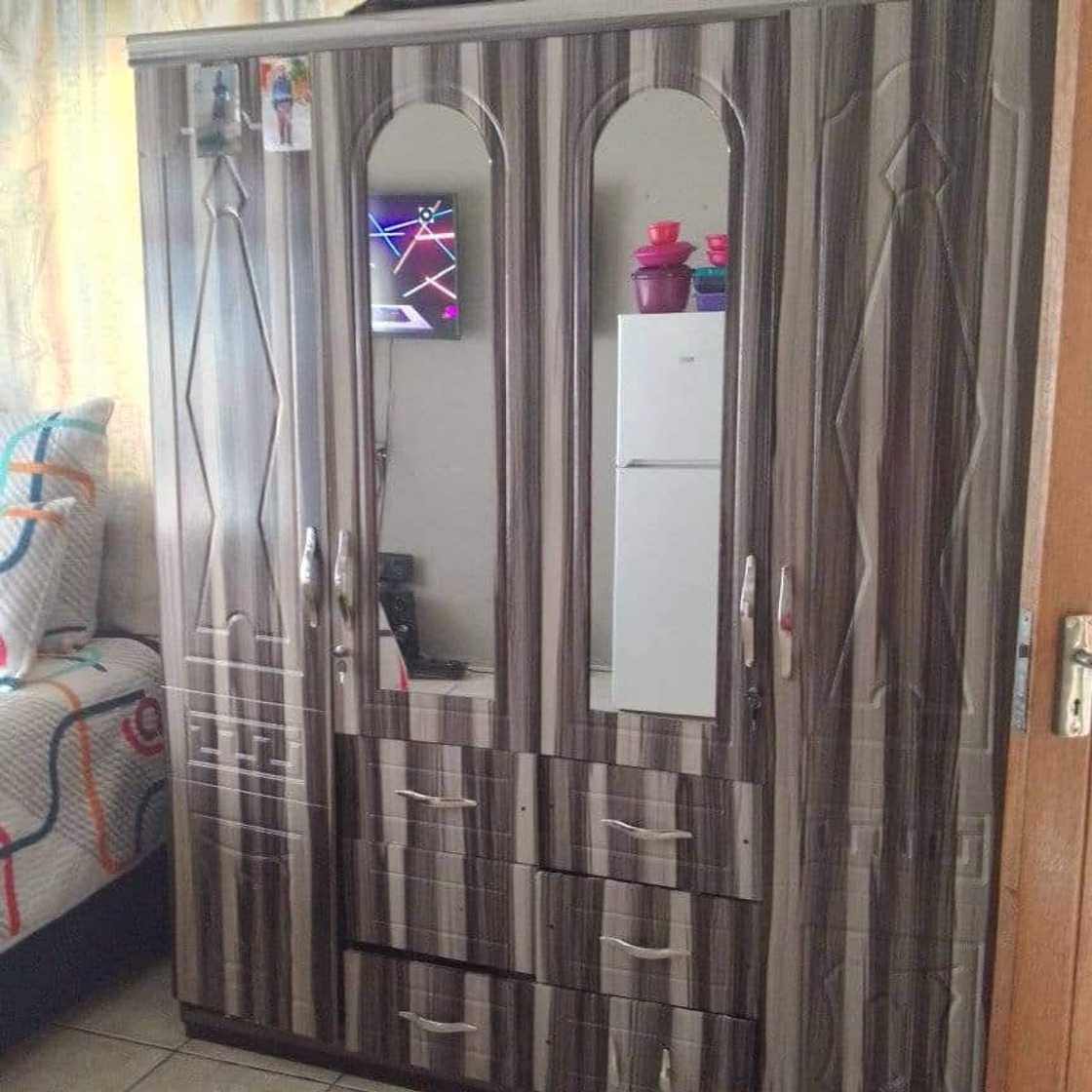 The lady shows of her storage space. The lady shows of her storage space.