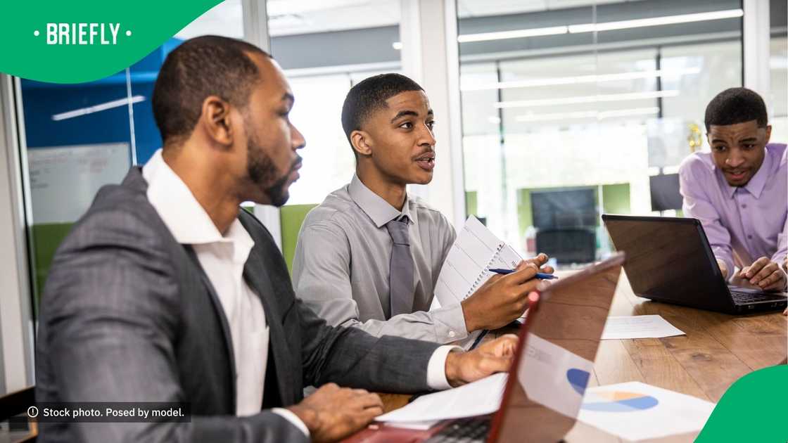 Men sitting at a table in the office. Men sitting at a table in the office.