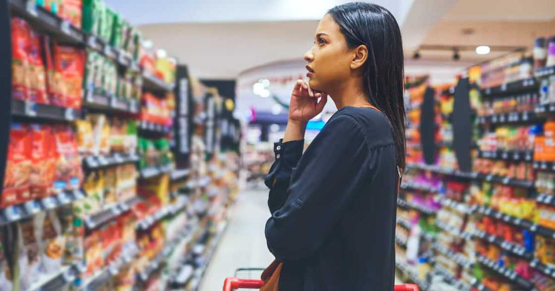 Shot of a young woman shopping in a grocery store