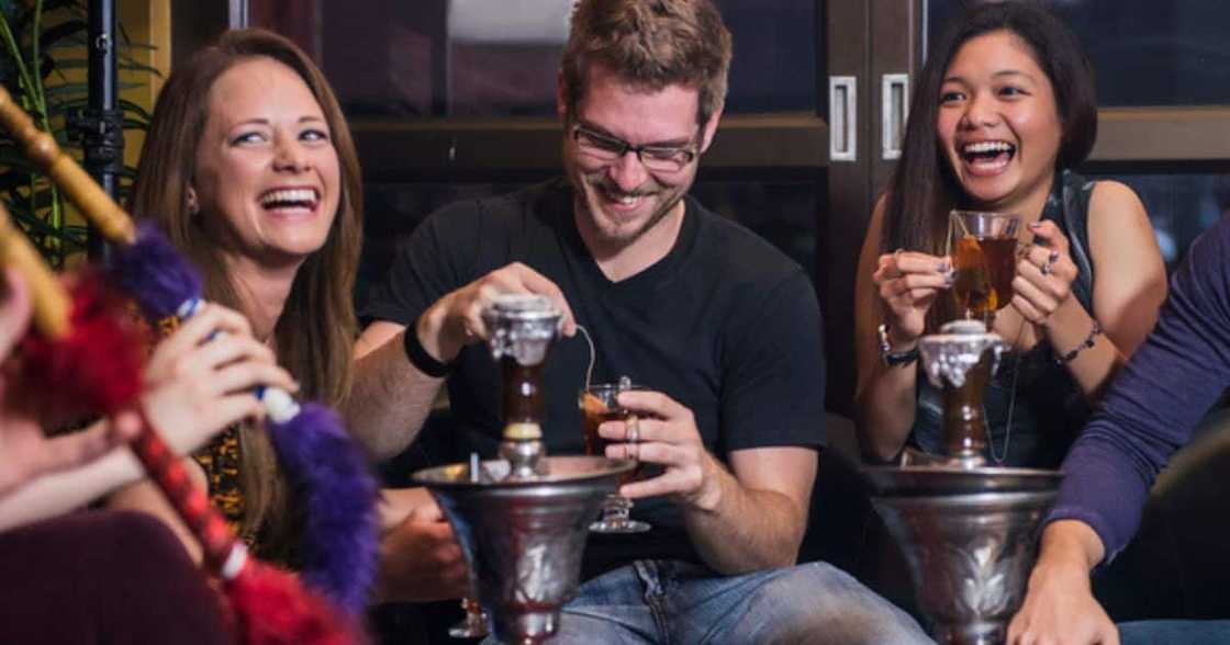 Stock image of friends smoking hubbly bubbly at the club Stock image of friends smoking hubbly bubbly at the club