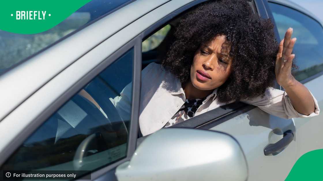 Adult woman showing frustration and road rage while stuck in traffic