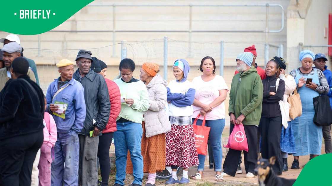 The image captured people standing to receive their SASSA grant