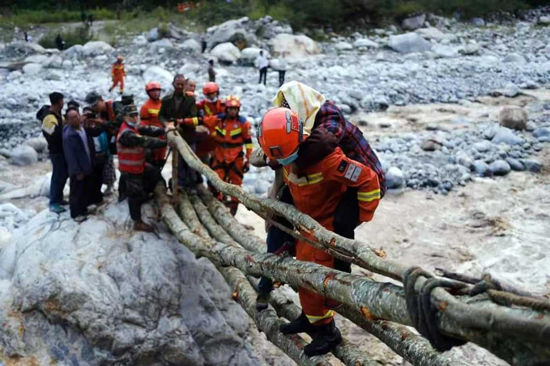 Rescue workers evacuate residents from Luding county in China's southwestern Sichuan province after Monday's devastating earthquake