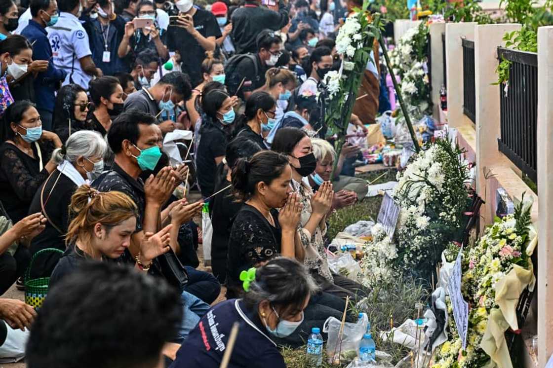 Families wept as they knelt outside the nursery in a ceremony to help release their children's souls Families wept as they knelt outside the nursery in a ceremony to help release their children's souls