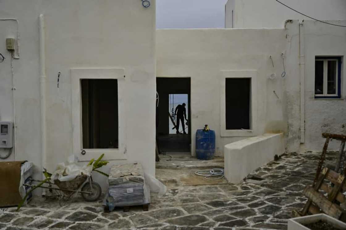 Workers busy on a site on the Greek island of Paros Workers busy on a site on the Greek island of Paros