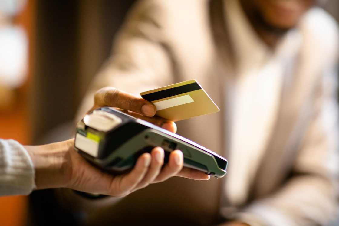 A man paying with a card. A man paying with a card.