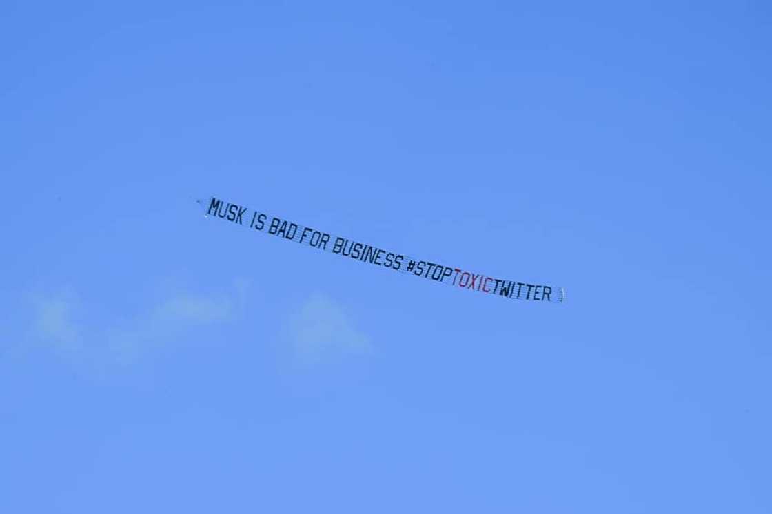 A banner reading, "Musk is Bad for Business #StopToxicTwitter" is flown over a conference venue in Miami, Florida where the Twitter CEO made a keynote address