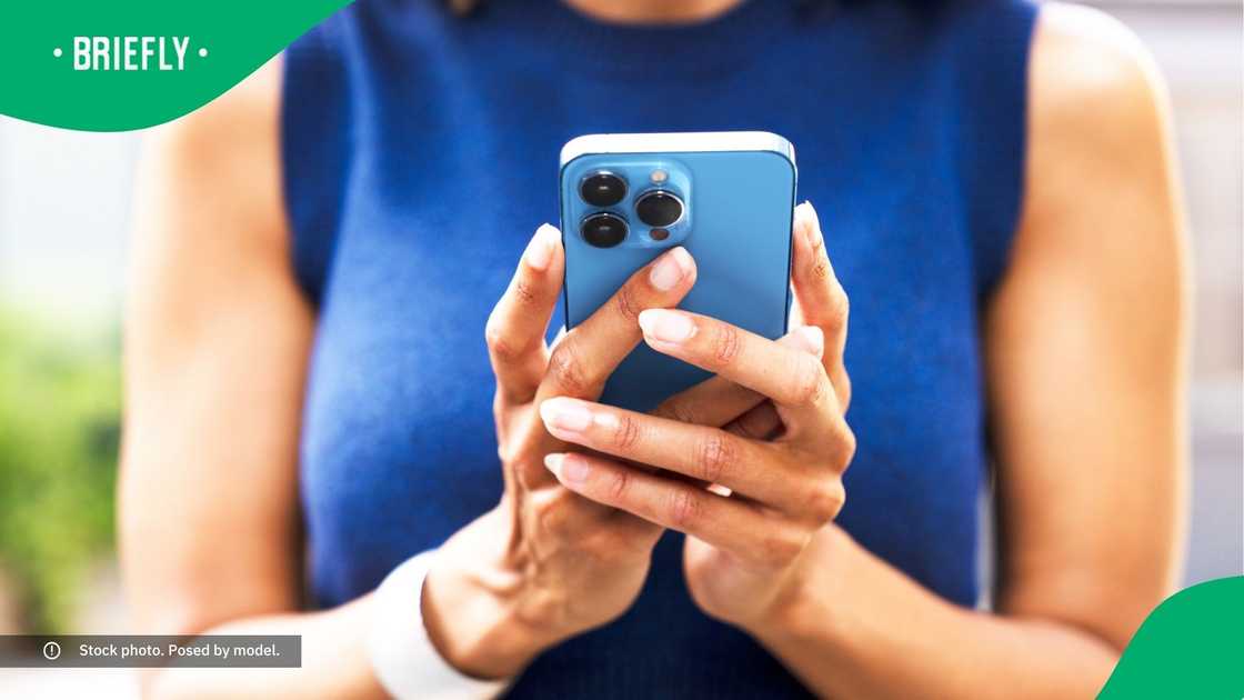 A woman typing on her phone. A woman typing on her phone.
