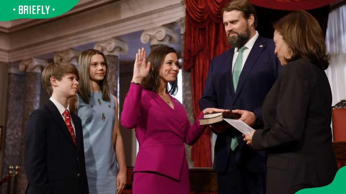 Katie Britt, her husband, and kids at her swearing-in by Kamala Harris in 2023