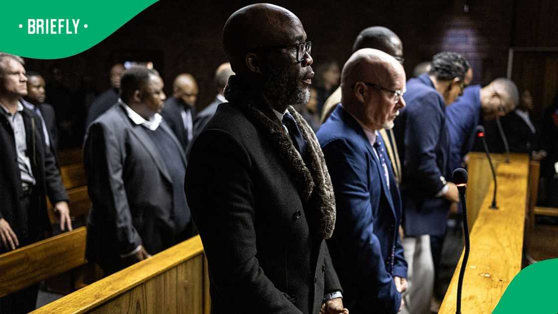 Vusimuzi "Cat" Matlala (C), suspected of links to organised crime, stands in the dock as he appears for charges linked to an irregular Medicare24 police tender, at the Pretoria Magistrate's Court in Pretoria on May 13, 2026