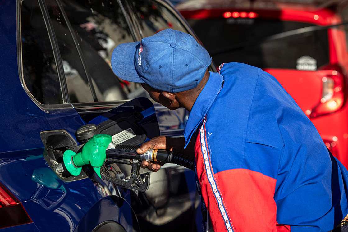 CAPE TOWN, SOUTH AFRICA - MARCH 31: A petrol attendant fills a car withl on March 31, 2026 in Cape Town, South Africa. Motorists in South Africa are expected to see the price of petrol rise by about 15% and diesel up to 40 percent