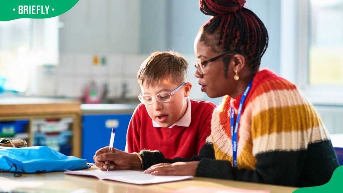 A teacher helping a student with his classwork