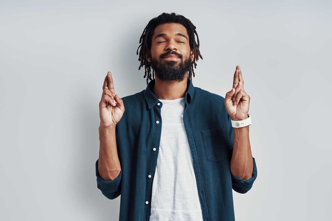 A man crossing his fingers. A man crossing his fingers.