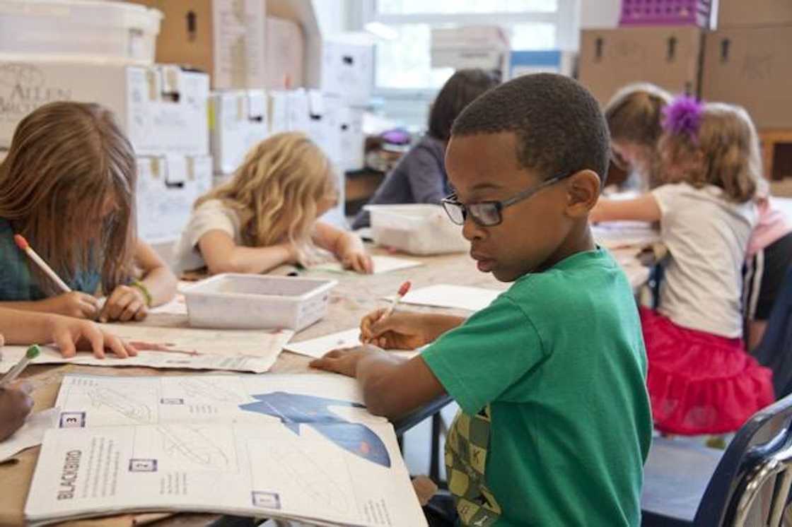 A group of children writing