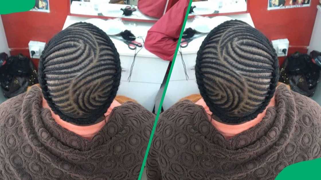 A lady flaunting detailed fishbone cornrows at the crown A lady flaunting detailed fishbone cornrows at the crown