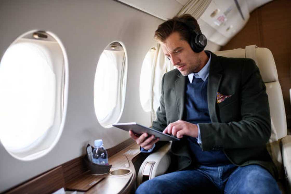 A man with headphones inside an airplane A man with headphones inside an airplane